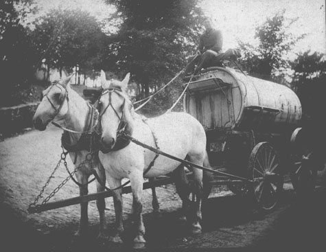 Jonathan Heroitt Ballard with team of horses pulling water wagon