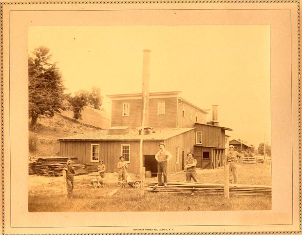 old photo of buildings along track